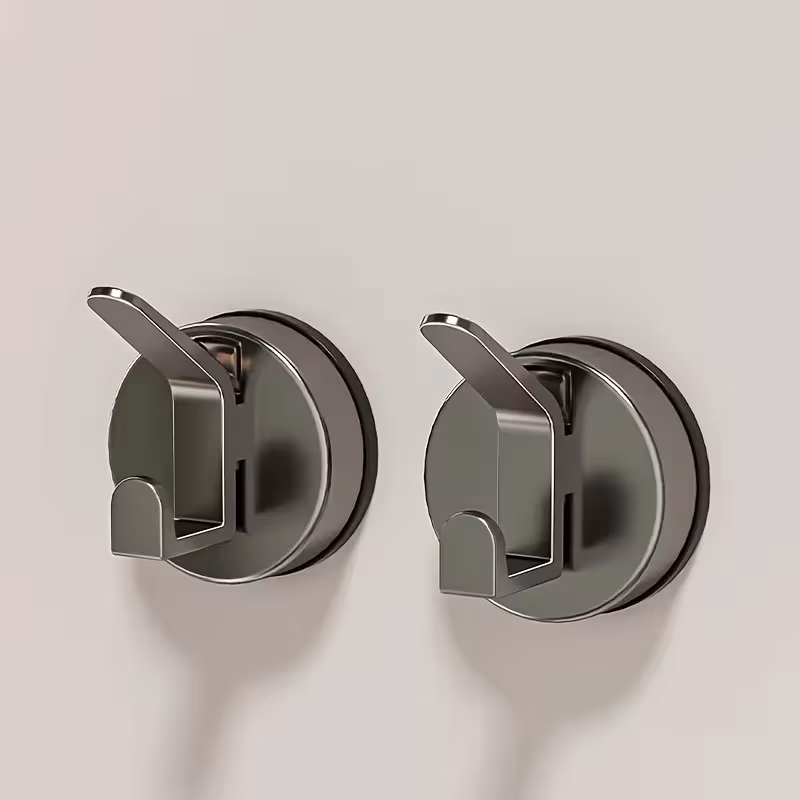 2 eleganti ganci in plastica con ventosa, resistenti a pesi elevati, da applicare alla parete.