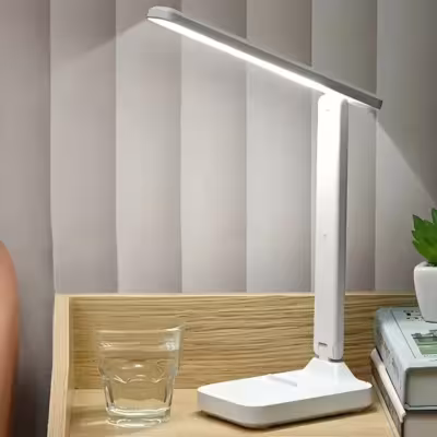 Lámpara de escritorio LED regulable con sensor táctil, con soporte para teléfono y conexión USB.